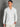 Man wearing a white shirt against a gray background